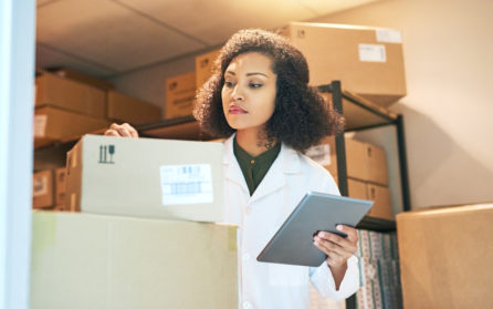 sorting through medical supply boxes